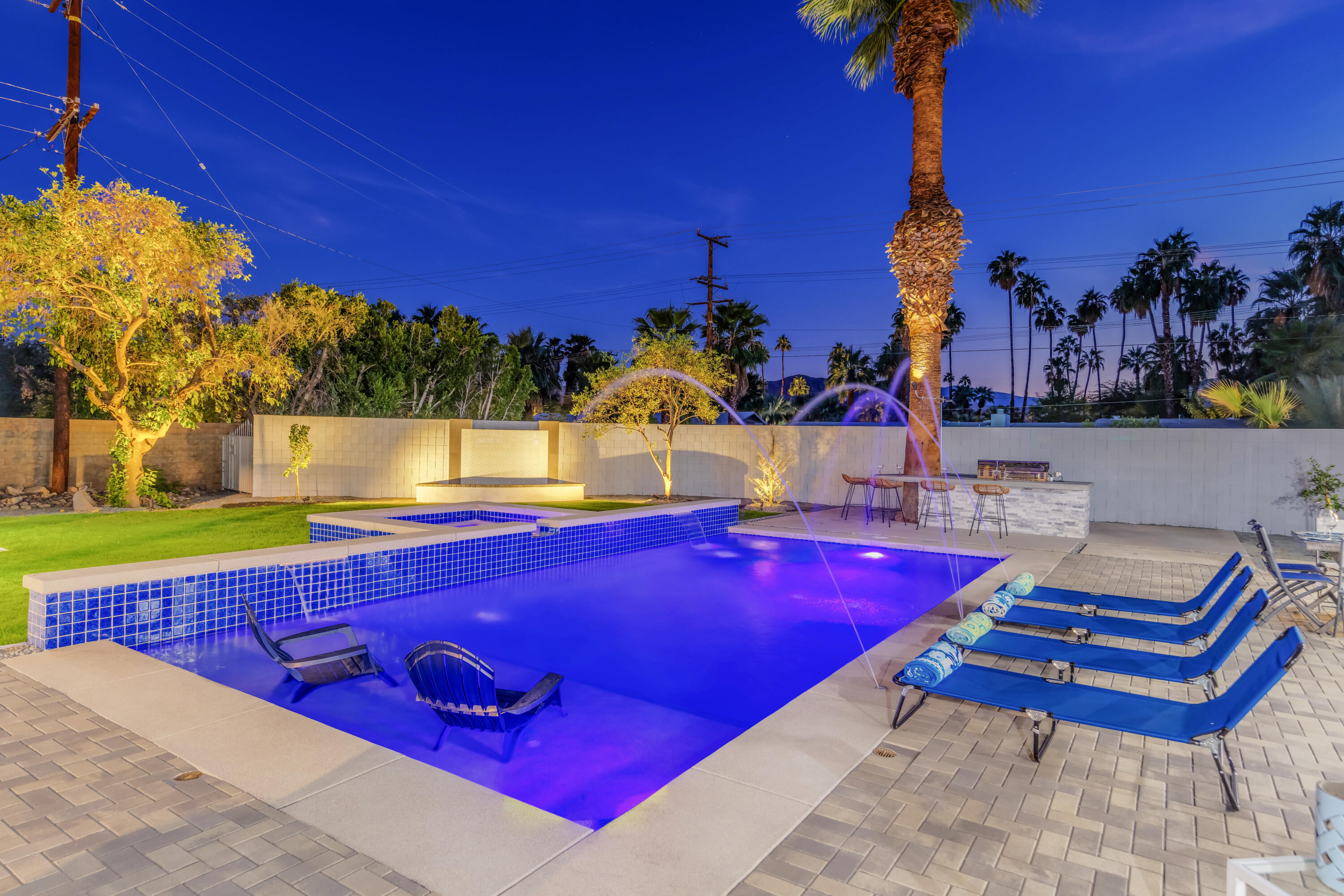 690 South Grenfall Road Palm Springs, CA 92264 - Photo 89 of 92 a view of a pool with seating area and trees in the background