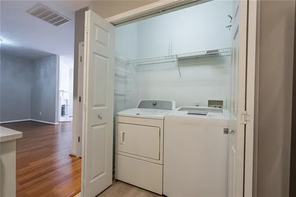 a view of washer and dryer with wooden floor