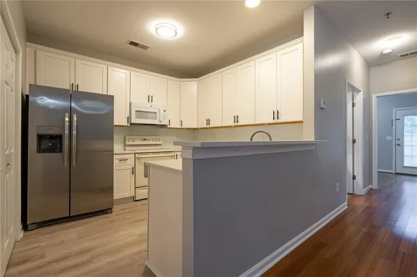 a kitchen with stainless steel appliances a refrigerator sink and cabinets