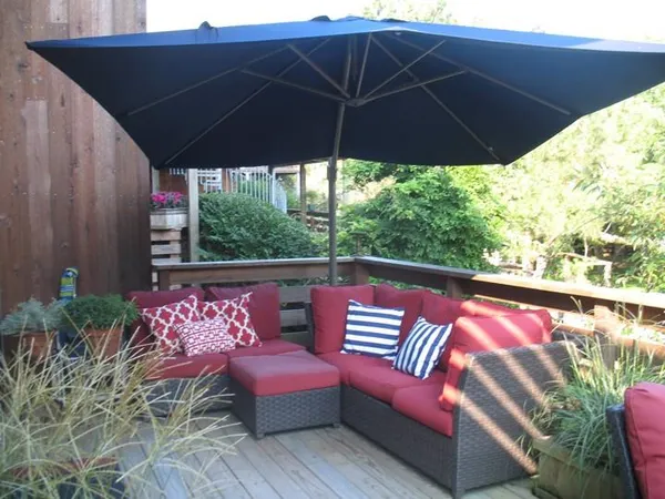 a roof deck with a table and chairs under an umbrella