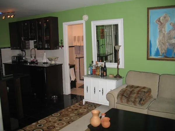 a living room with furniture and a lamp