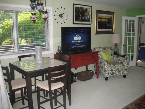 a living room with furniture a chandelier and a fireplace
