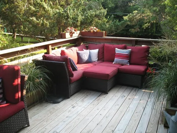 a balcony with furniture and a potted plant
