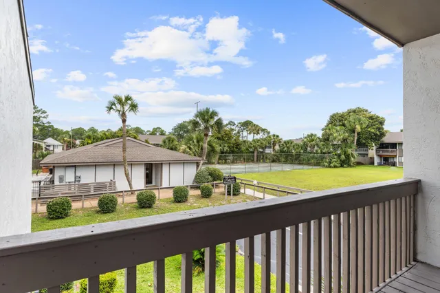 a view of a house with a swimming pool and a yard