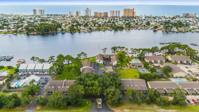 an aerial view of residential houses with outdoor space and lake view