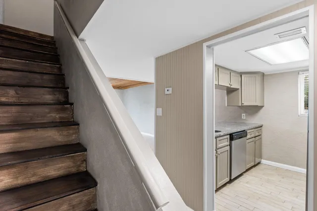 a view of kitchen with sink and an entryway