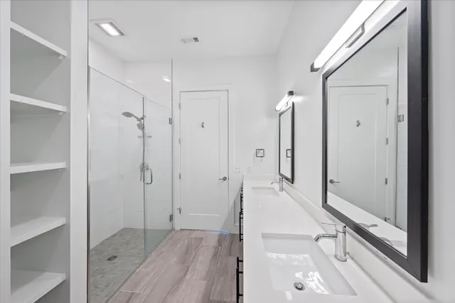 a bathroom with a shower and a mirror