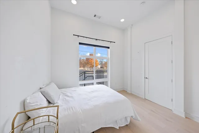 a bedroom with a bed and a window