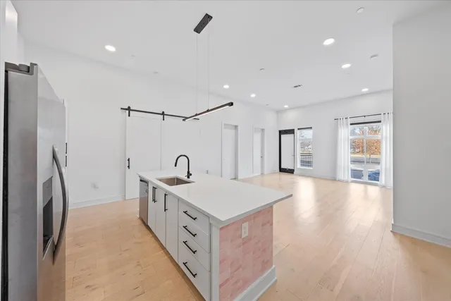 a kitchen with stainless steel appliances a sink stove and refrigerator