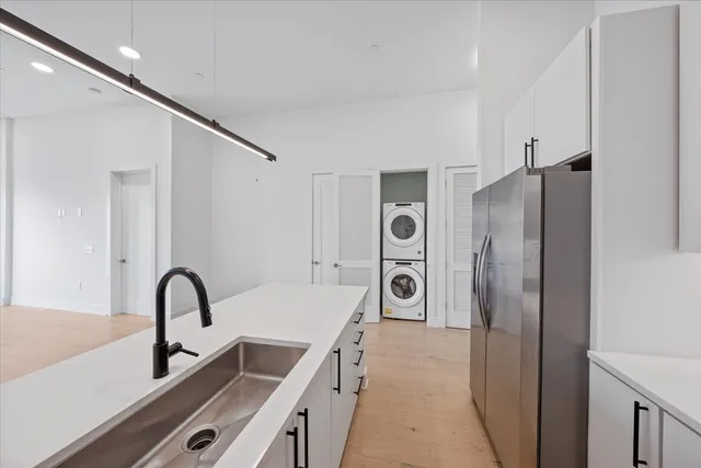 a kitchen with a refrigerator and a sink