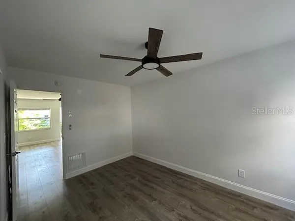 a view of a room with wooden floor and windows