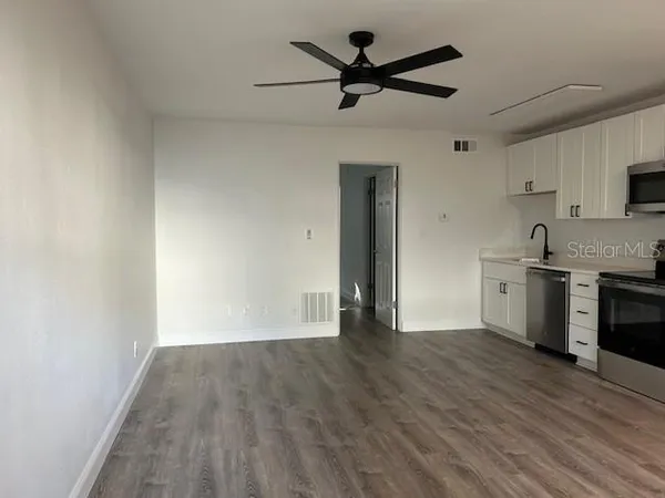 a view of a kitchen with a sink and a refrigerator