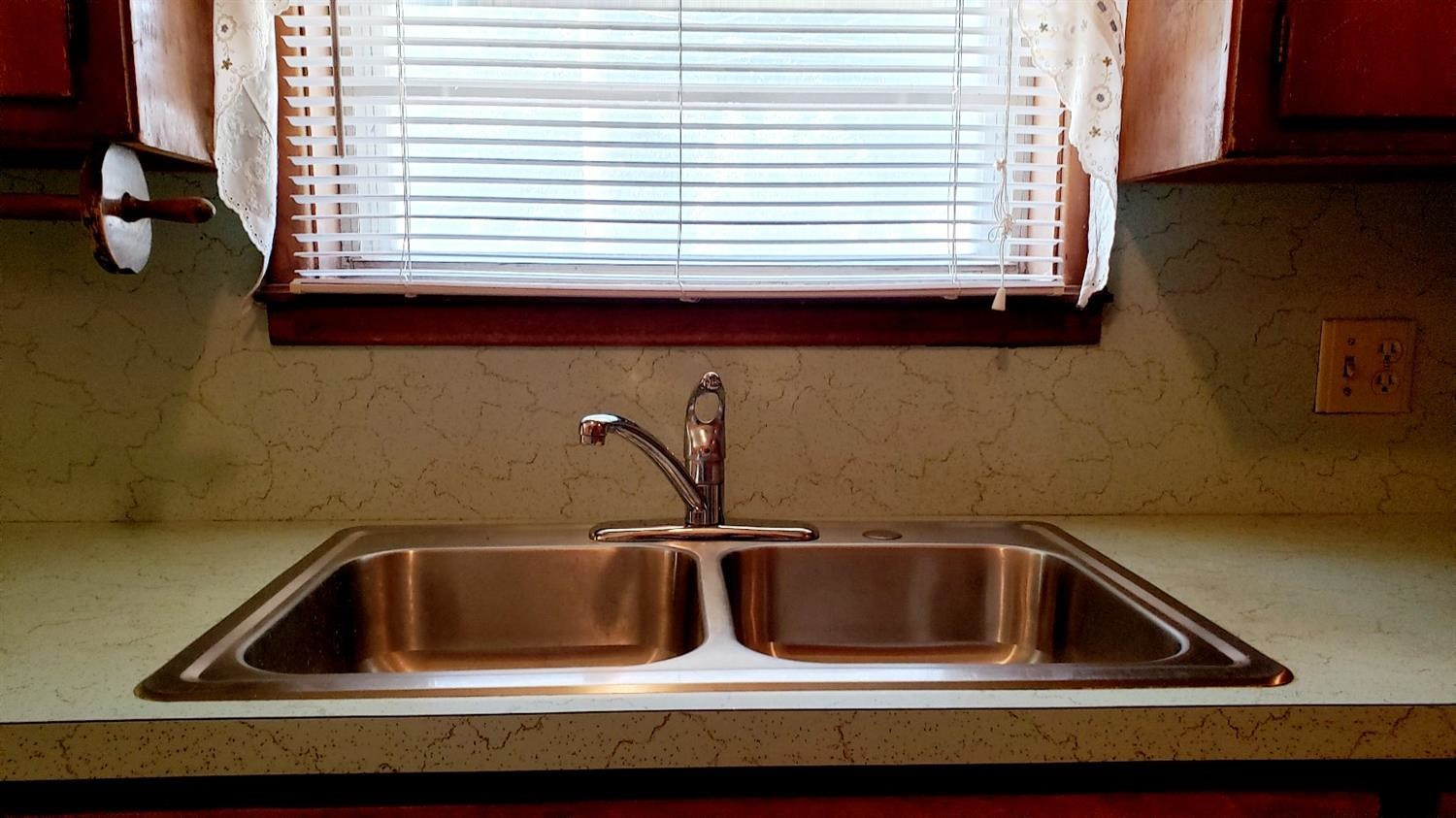 5419 46th Street Lubbock, TX 79414 - Photo 14 of 36 a kitchen with a sink and a window