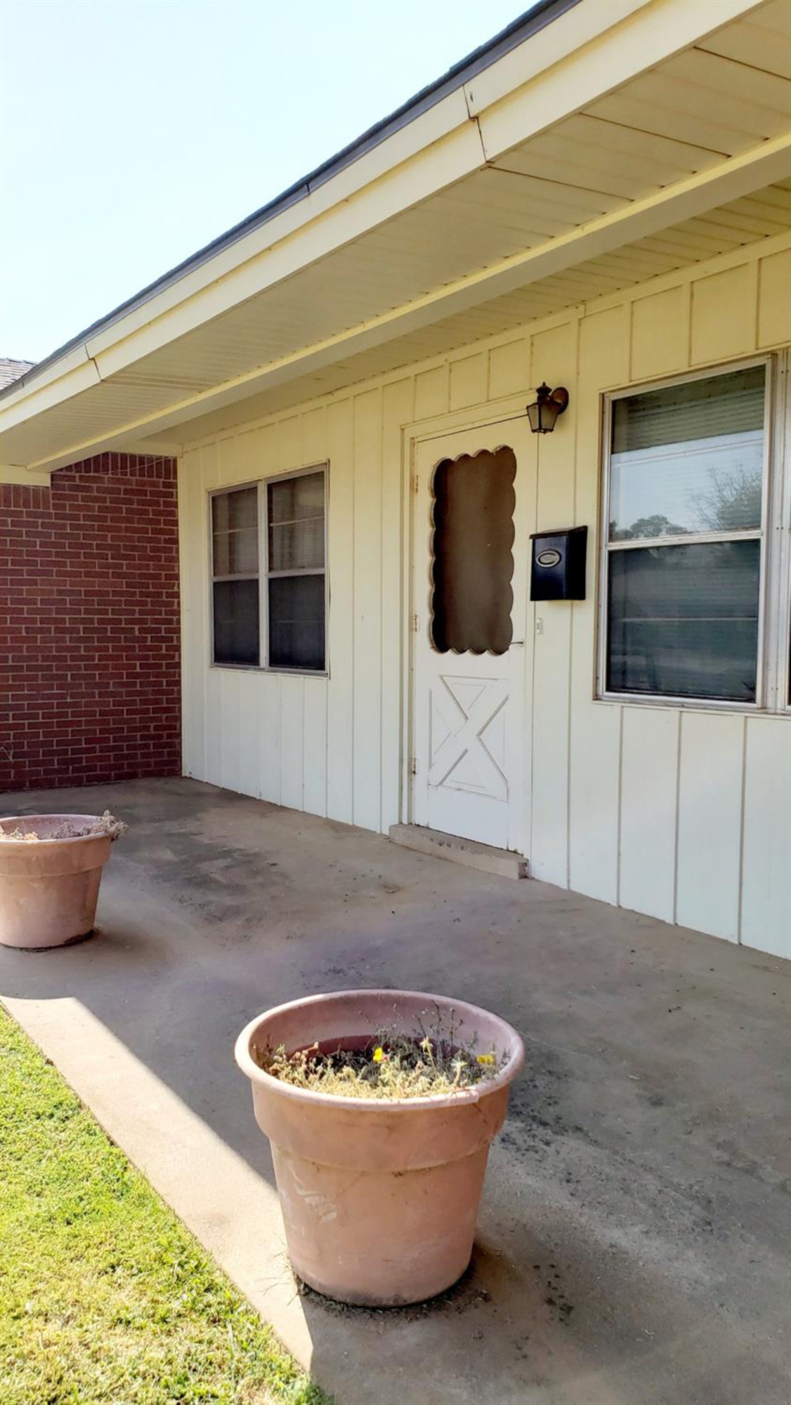5419 46th Street Lubbock, TX 79414 - Photo 2 of 36 a living room with a couch and a flat screen tv