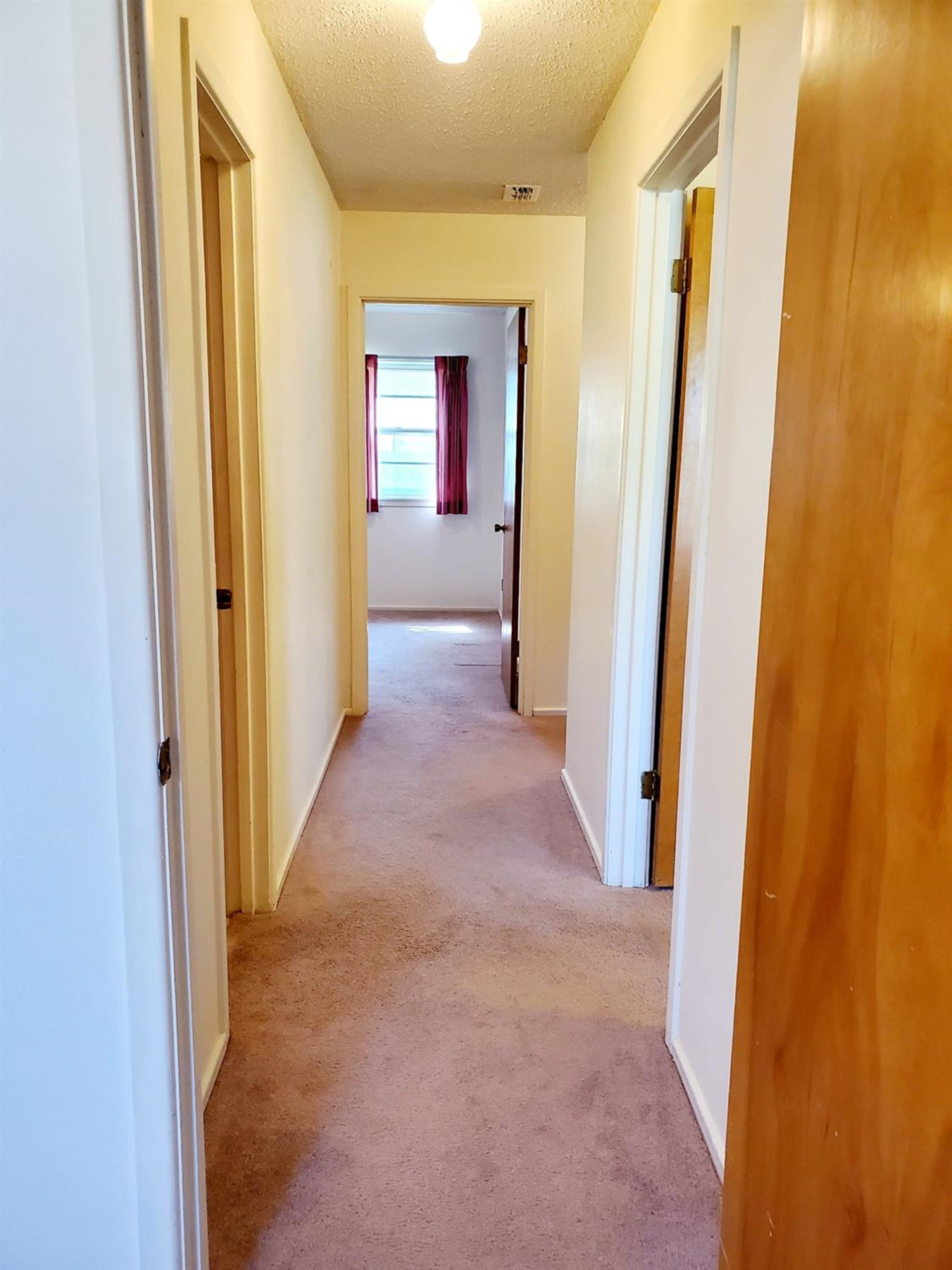 5419 46th Street Lubbock, TX 79414 - Photo 8 of 36 a view of a hallway with wooden floor and a living room