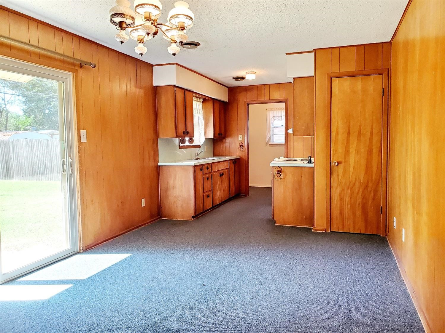 5419 46th Street Lubbock, TX 79414 - Photo 9 of 36 a living room with stainless steel appliances granite countertop furniture a chandelier and a window