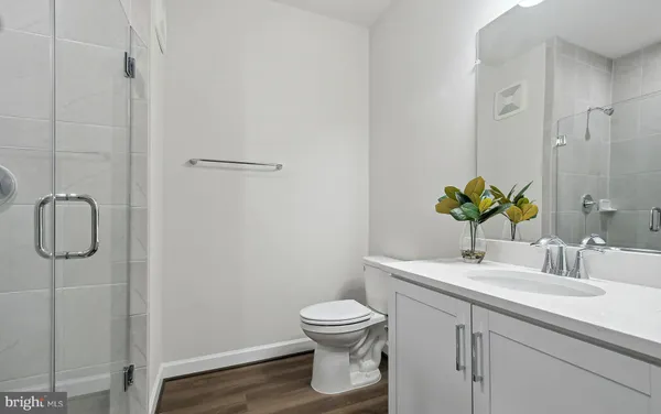 a front view of a house with a garden and plants