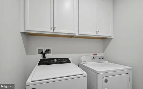 a living room with a table and a microwave