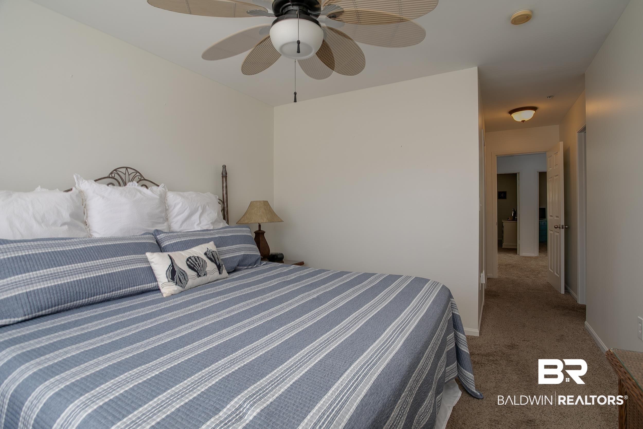 1517 Regency Road, Unit 33 Gulf Shores, AL 36542 - Photo 16 of 29 Bedroom with baseboards, carpet, and a ceiling fan