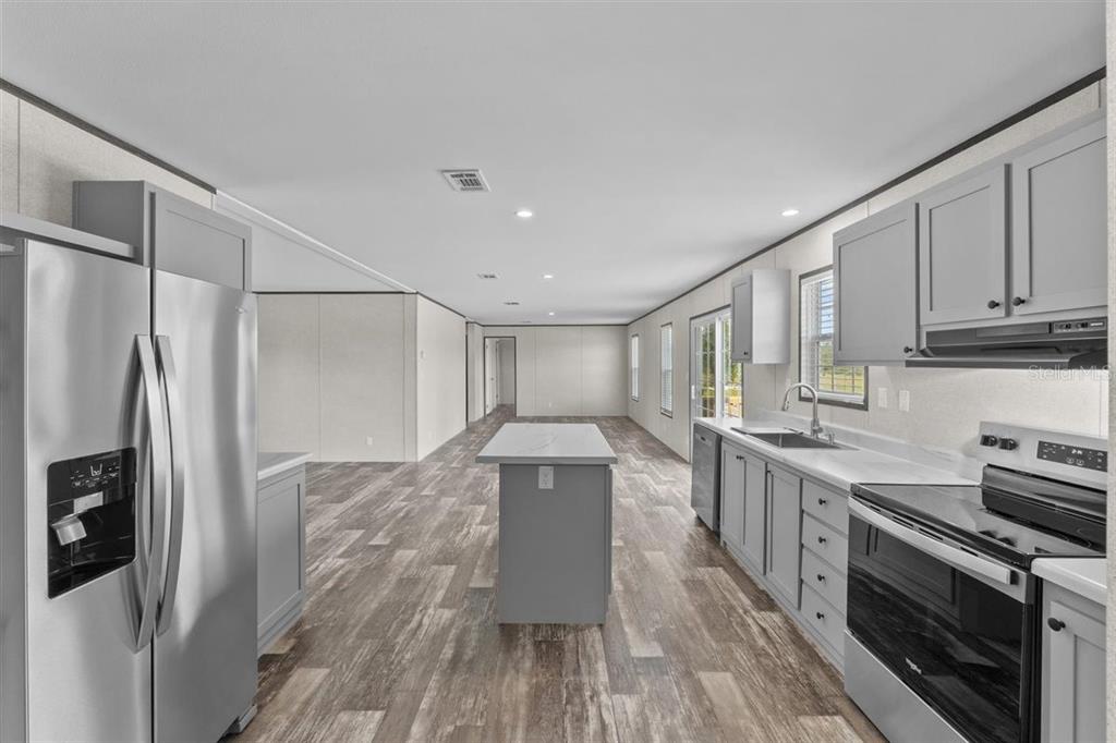 0 Rose Trail Hawthorne, FL 32640 - Photo 21 of 36 a kitchen with stainless steel appliances a refrigerator sink and stove