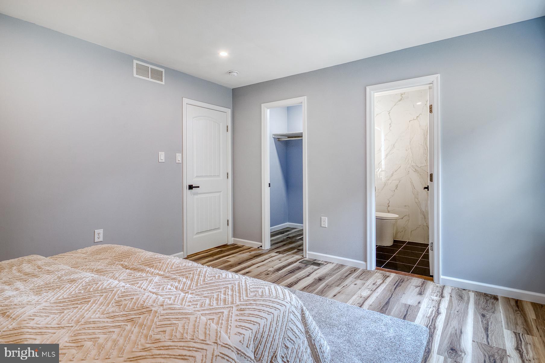 4108 Century Towne Road Randallstown, MD 21133 - Photo 24 of 51 a bedroom with a bed and wooden floor