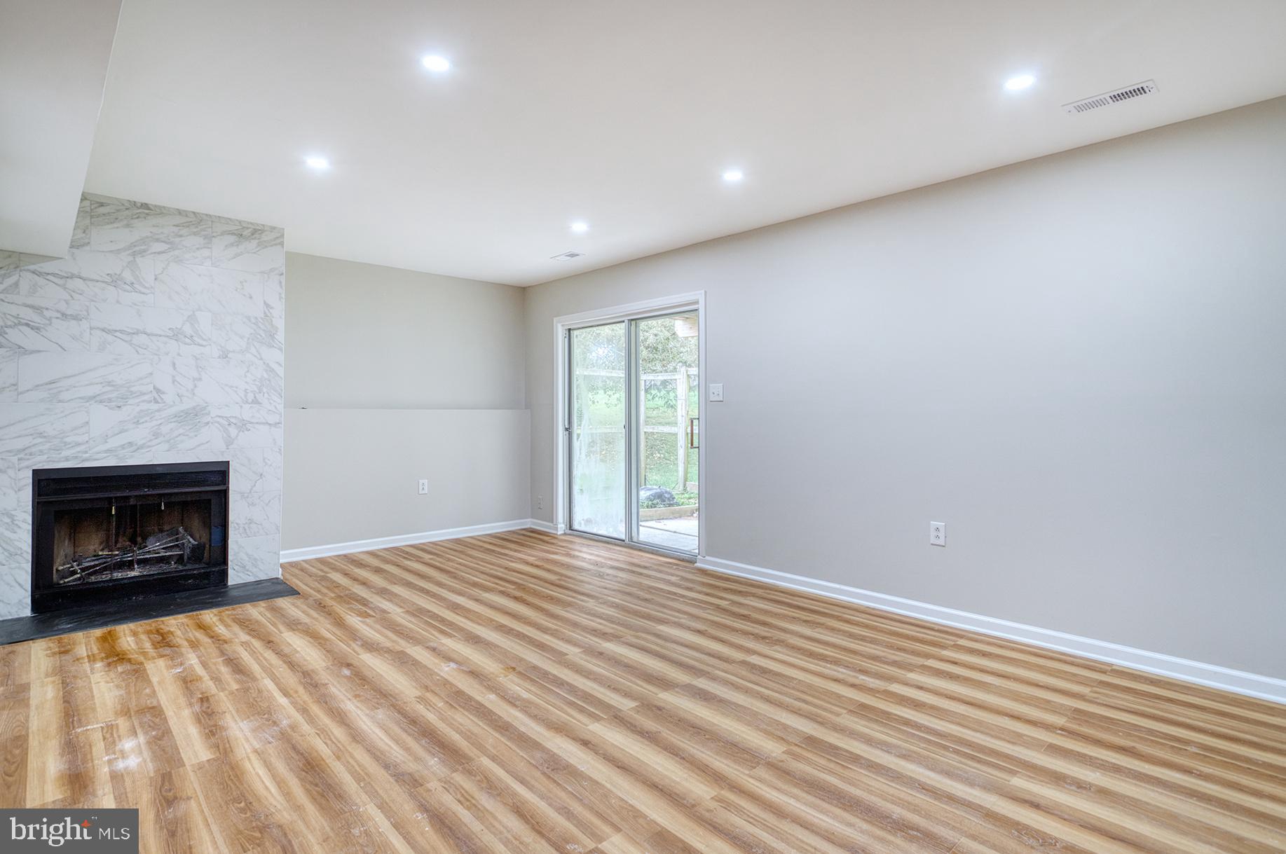 4108 Century Towne Road Randallstown, MD 21133 - Photo 36 of 51 a view of an empty room with a fireplace and a window