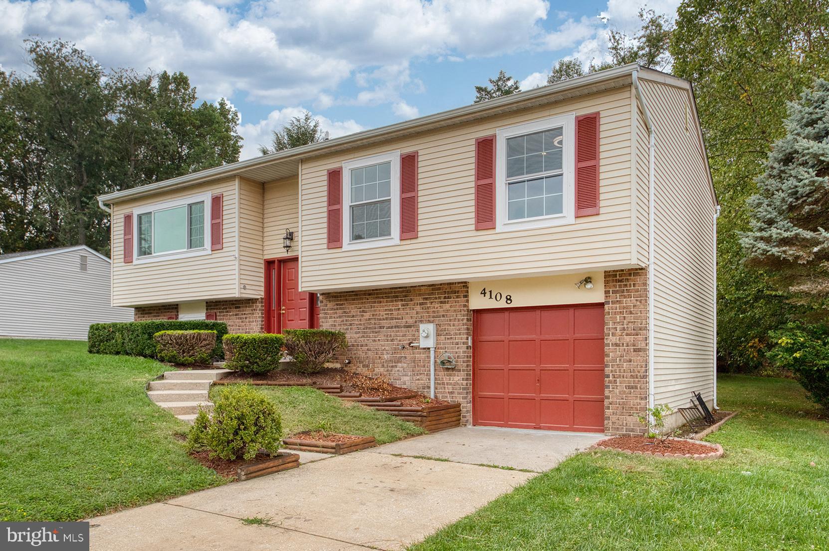 4108 Century Towne Road Randallstown, MD 21133 - Photo 48 of 51 a front view of a house with a yard and garage