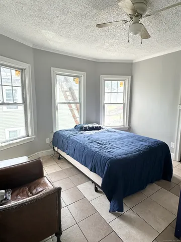 a spacious bedroom with a bed and window