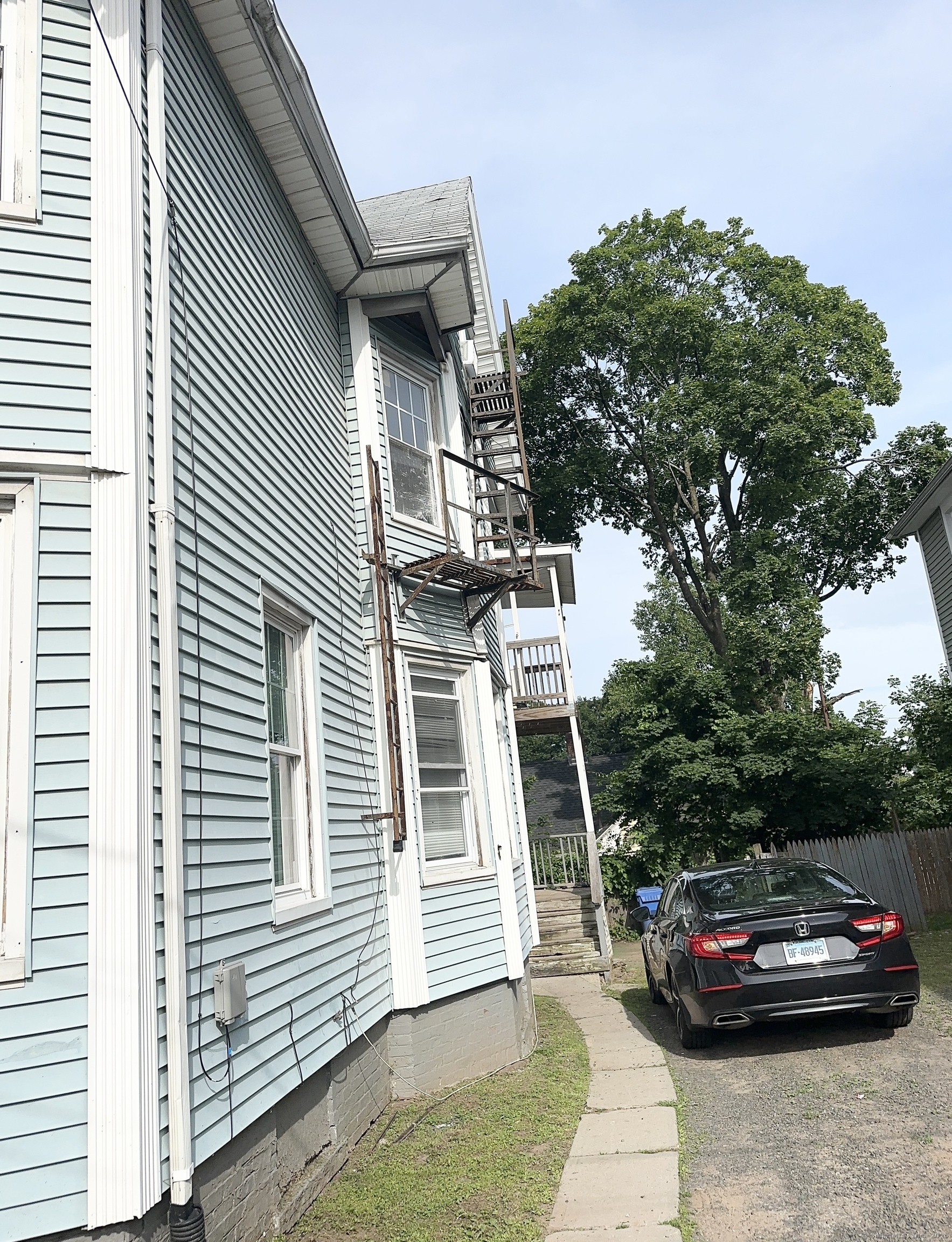 49 Prospect Street Meriden, CT 06451 - Photo 2 of 11 a front view of a house with a garden