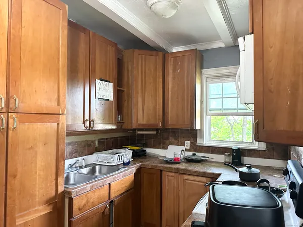 a room with a window a sink and a counter top space