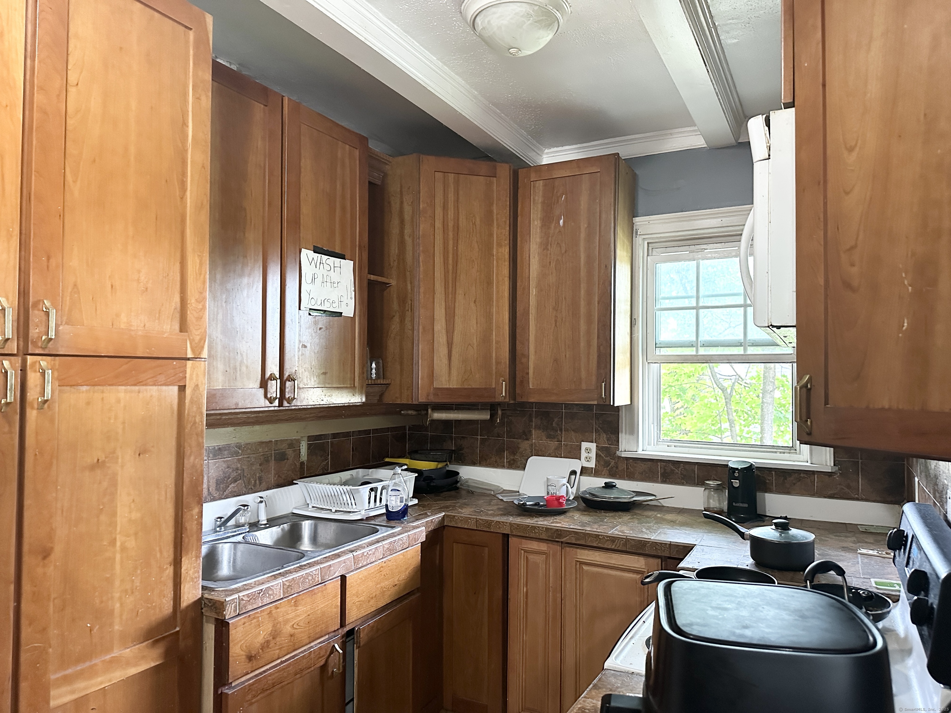 49 Prospect Street Meriden, CT 06451 - Photo 3 of 11 a room with a window a sink and a counter top space
