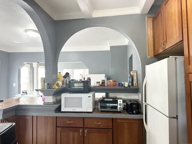 a kitchen with refrigerator and cabinets