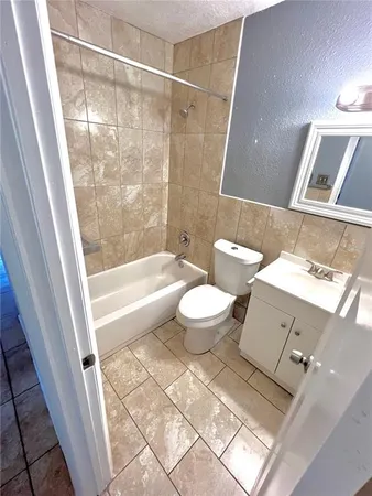 a bathroom with a bathtub and a toilet