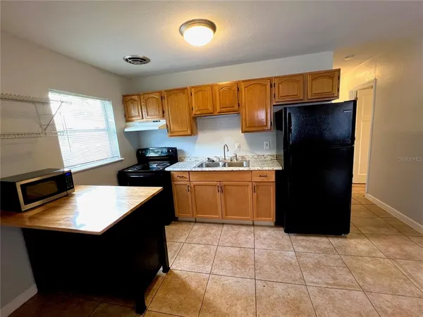 a kitchen with a cabinets and a refrigerator