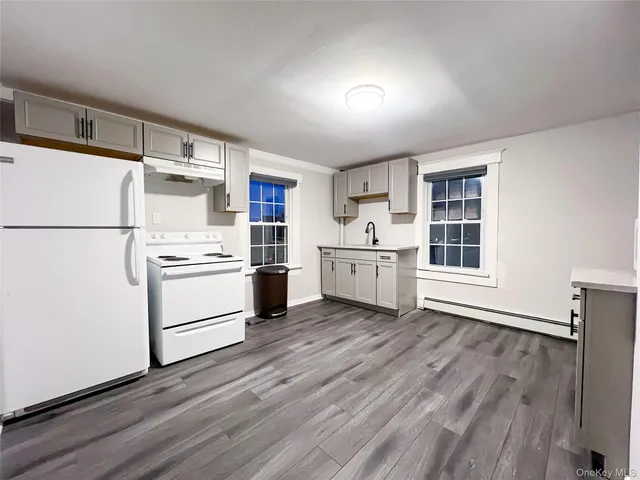 a kitchen with white cabinets and white appliances