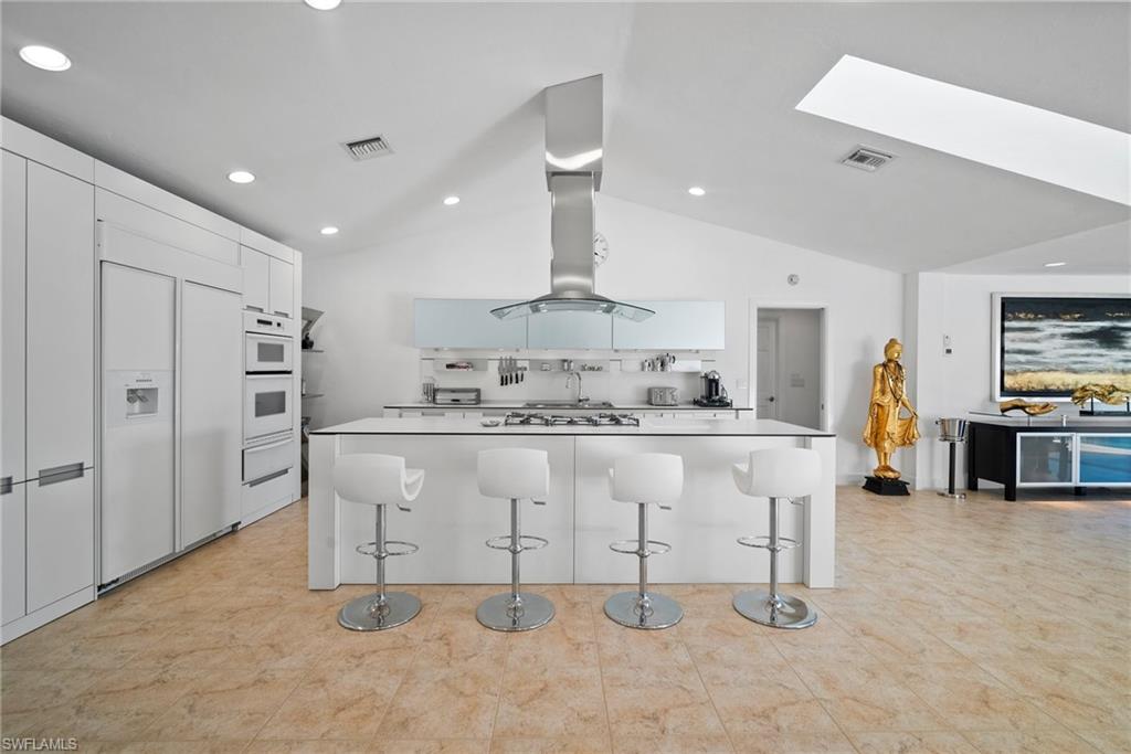 319 Pirates Bight Naples, FL 34103 - Photo 11 of 26 a kitchen with stainless steel appliances granite countertop a sink and a refrigerator