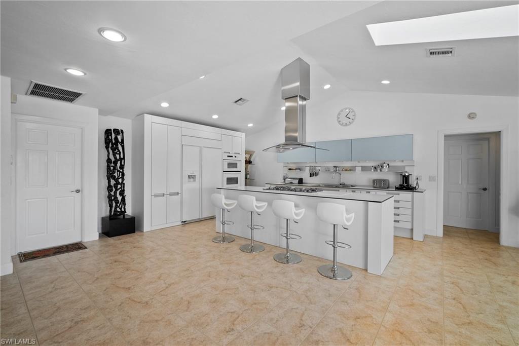 319 Pirates Bight Naples, FL 34103 - Photo 12 of 26 a kitchen with white cabinets