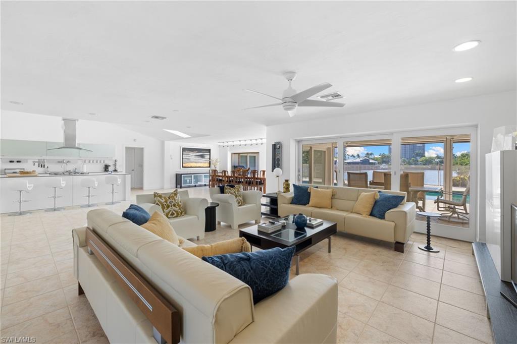 319 Pirates Bight Naples, FL 34103 - Photo 14 of 26 a living room with furniture and a large window