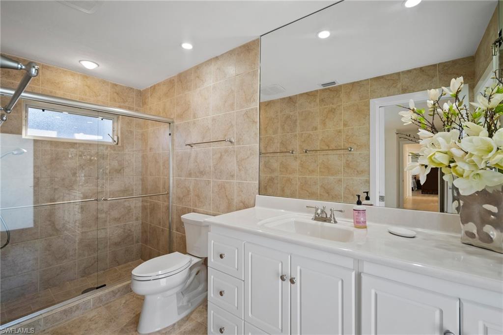 319 Pirates Bight Naples, FL 34103 - Photo 20 of 26 a bathroom with a sink a toilet and shower