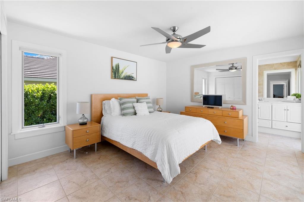 319 Pirates Bight Naples, FL 34103 - Photo 21 of 26 a bed room with a bed and a window