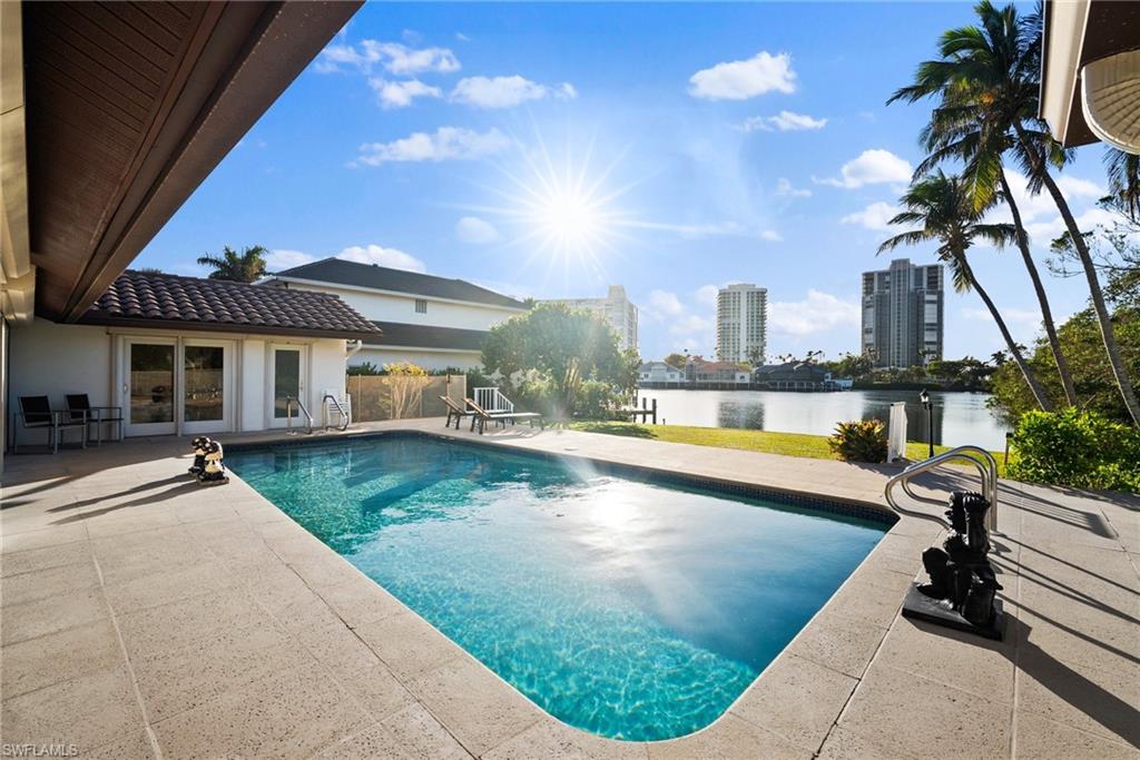 319 Pirates Bight Naples, FL 34103 - Photo 6 of 26 a view of a house with swimming pool and sitting area