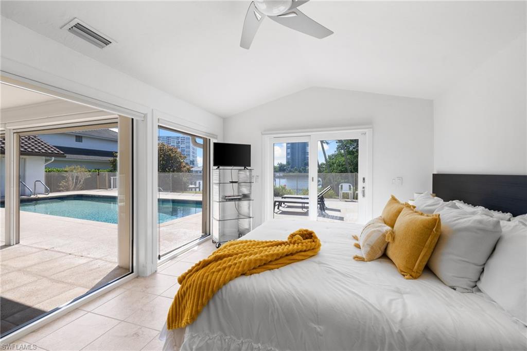 319 Pirates Bight Naples, FL 34103 - Photo 7 of 26 a bedroom with a bed and glass door