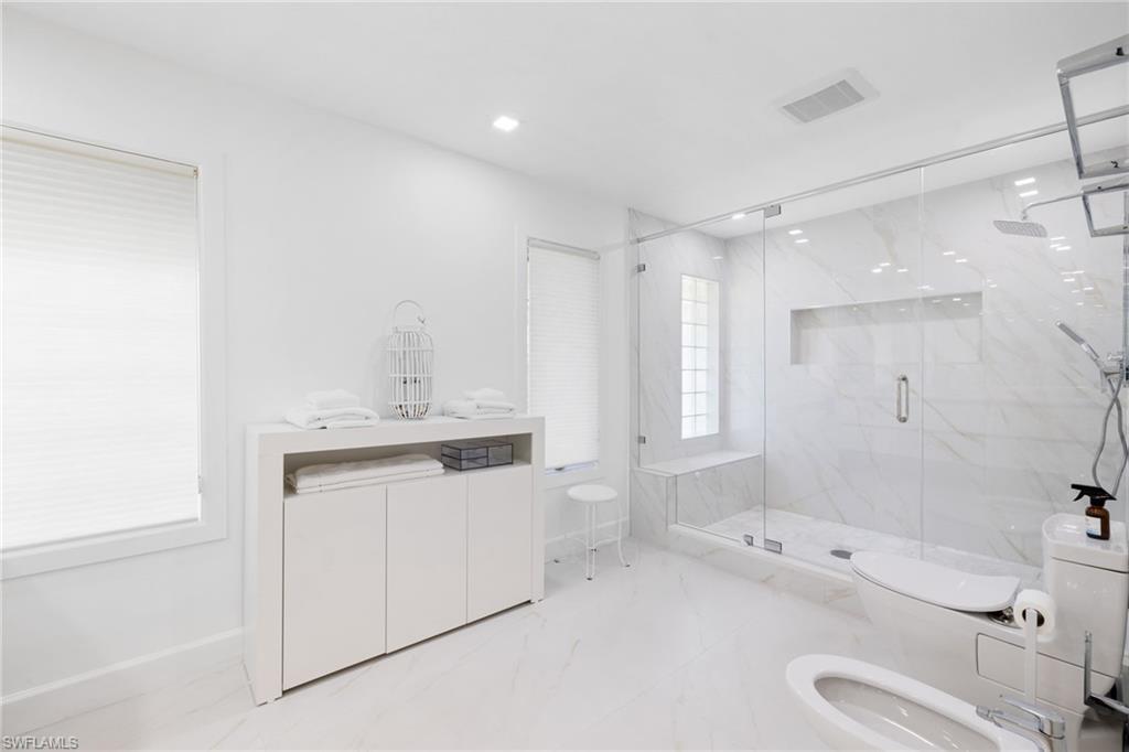 319 Pirates Bight Naples, FL 34103 - Photo 9 of 26 a bathroom with a granite countertop sink mirror bathtub and shower