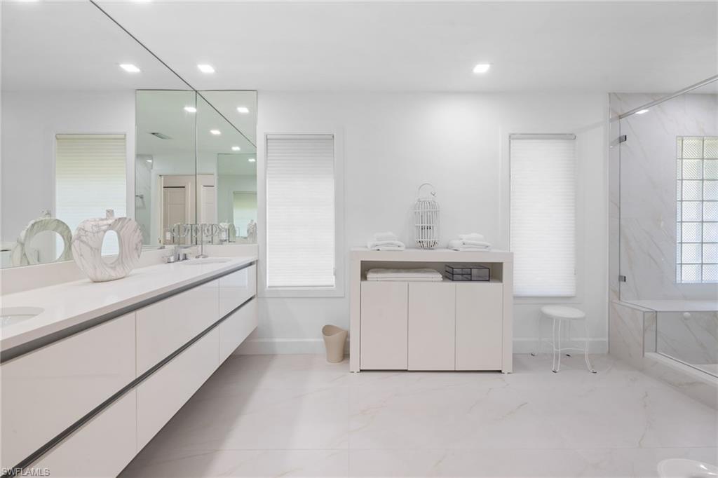 319 Pirates Bight Naples, FL 34103 - Photo 10 of 26 a bathroom with a sink double vanity and a mirror