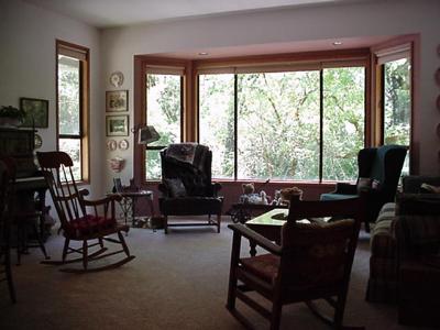 8892 Cider Springs Road Sebastopol, CA 95472 - Photo 8 of 9 a living room with furniture and floor to ceiling windows