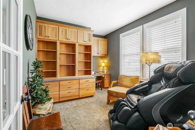 a living room with furniture windows and a potted plant