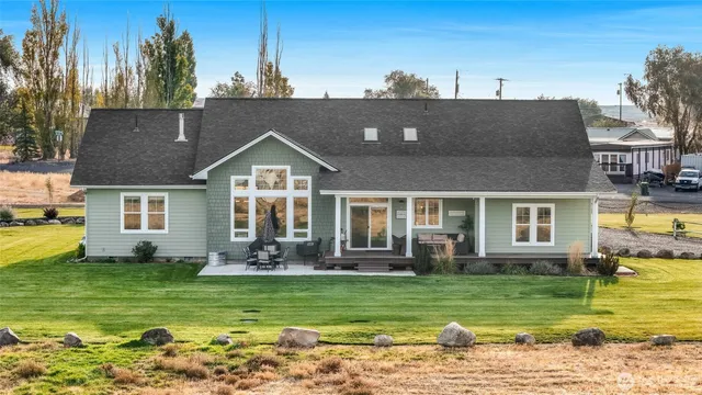 a front view of a house with a garden and plants