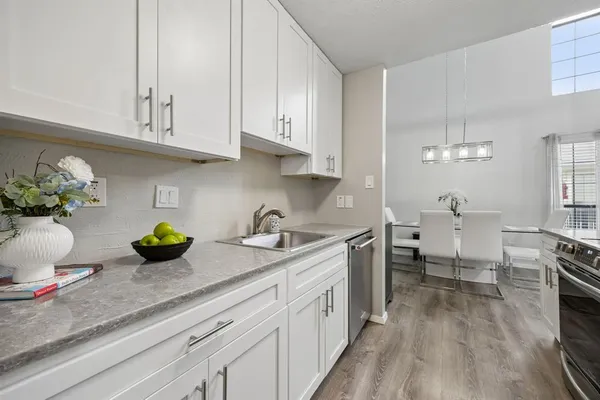 a kitchen with sink cabinets and wooden floor