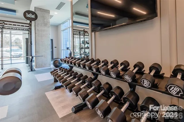 a view of a refrigerator in kitchen and an empty room