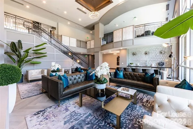 a living room with furniture ceiling fan and a rug